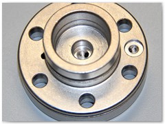 Hydraulic circuit End cap made from 12L14 steel and nickel plated. Produced on a 8 axis lathe.