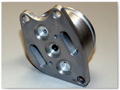 Electromagnetic servo valve component with internal circuit precision deburred under magnification.